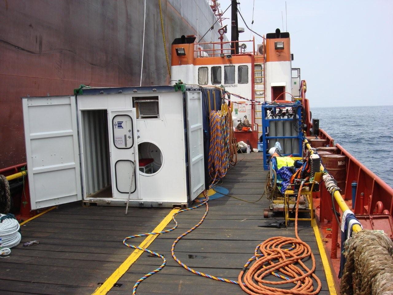 Containerized commercial diving spread mobilized on a work vessel