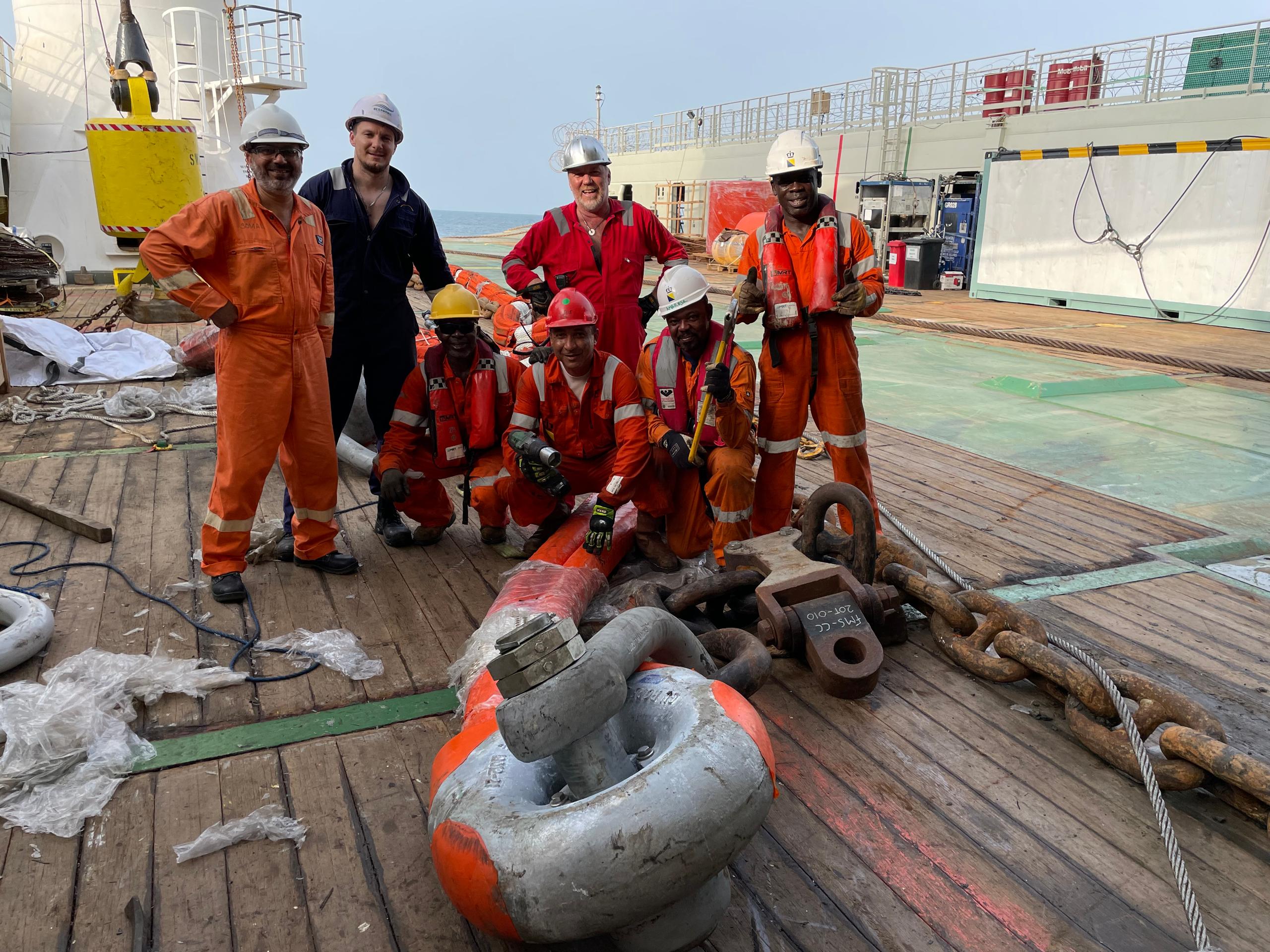 Aberport and project personnel with recovered mooring components on deck